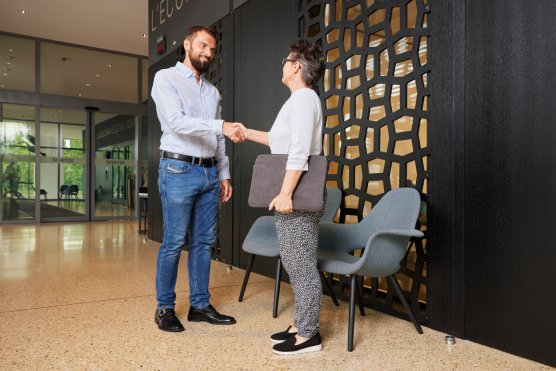 person standing and shaking hands