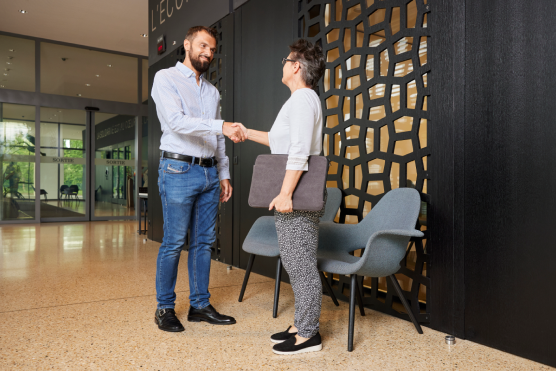 person standing and shaking hands
